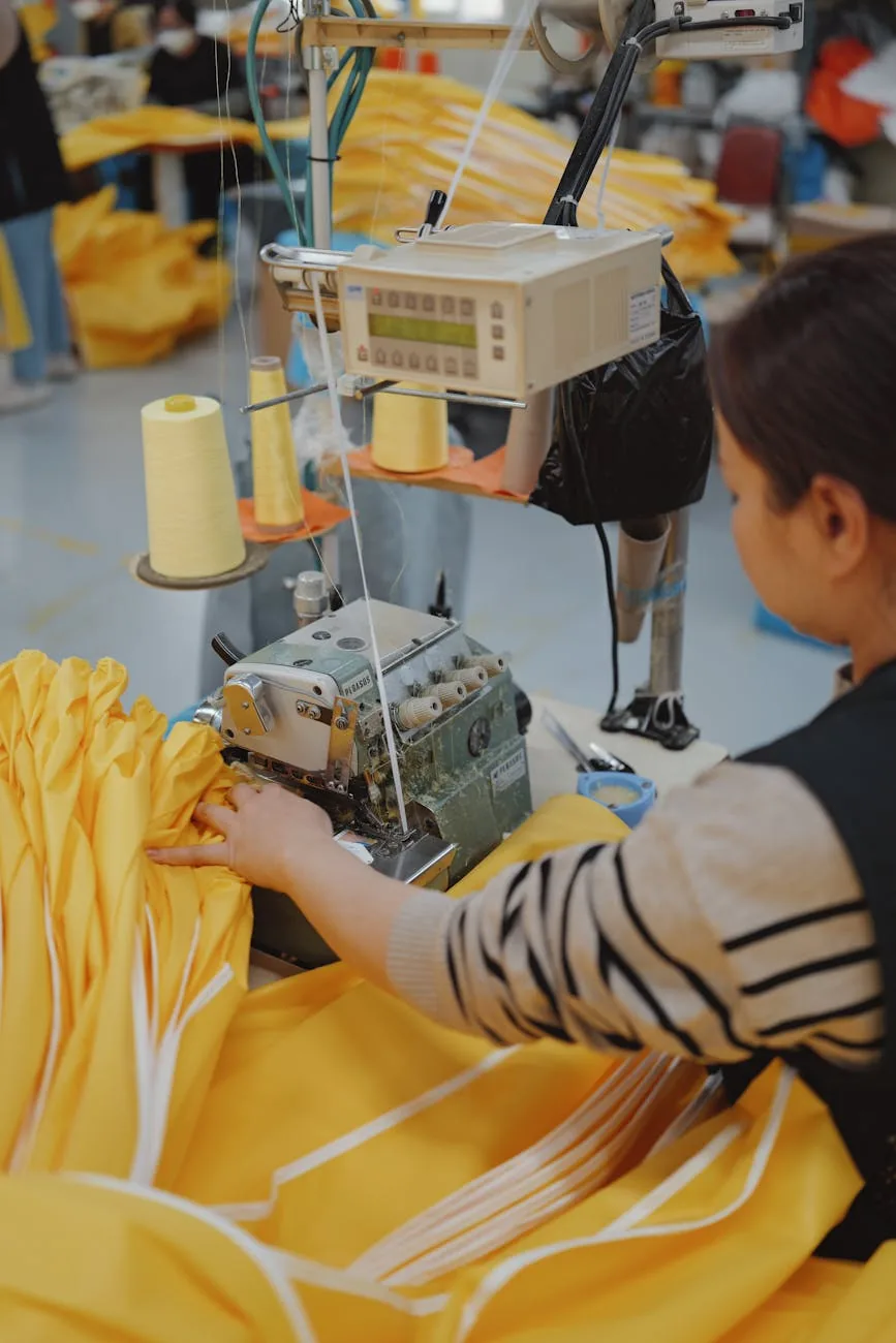 Operator at an industrial sewing machine on a garment factory line